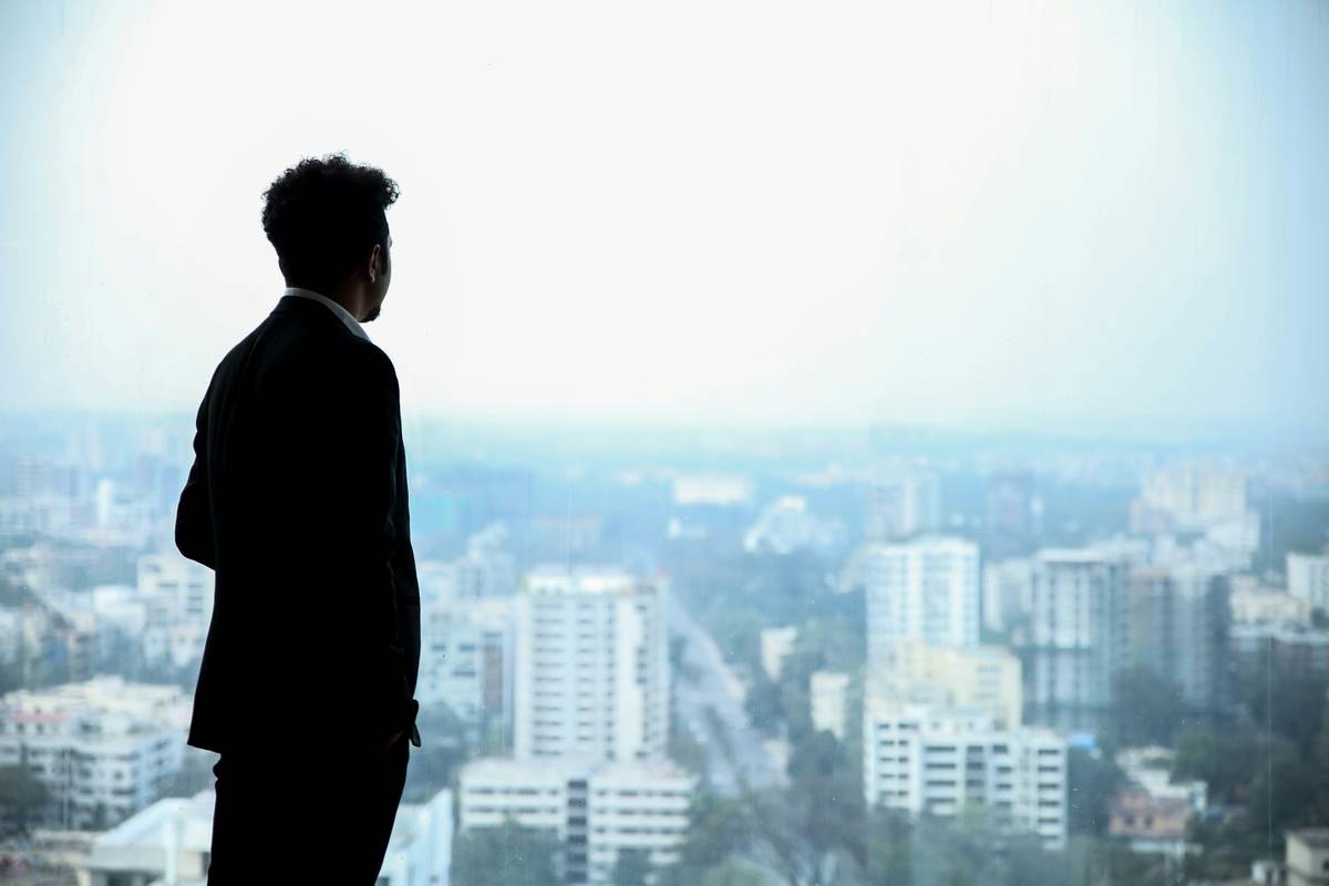 wealth entrepreneurship psychology: entrepreneur meditating with financial charts in background